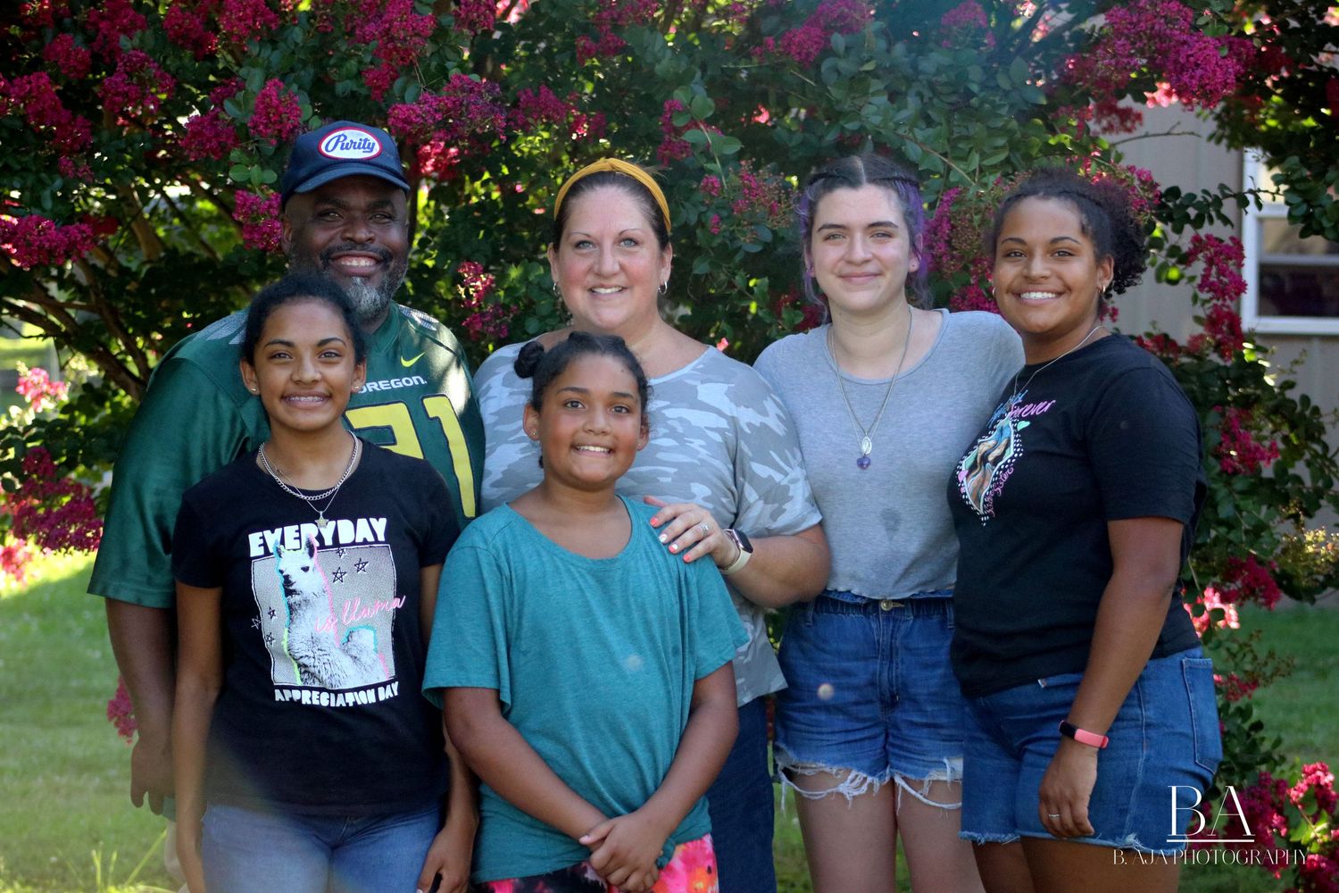 Group, family photo of husband and wife with their 4 daughters.