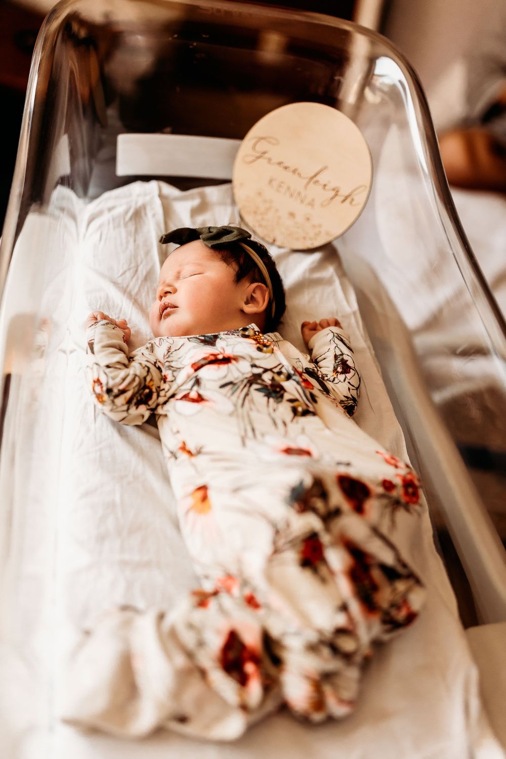 Precious newborn girl laying in the bassinet during her fresh 48 session.