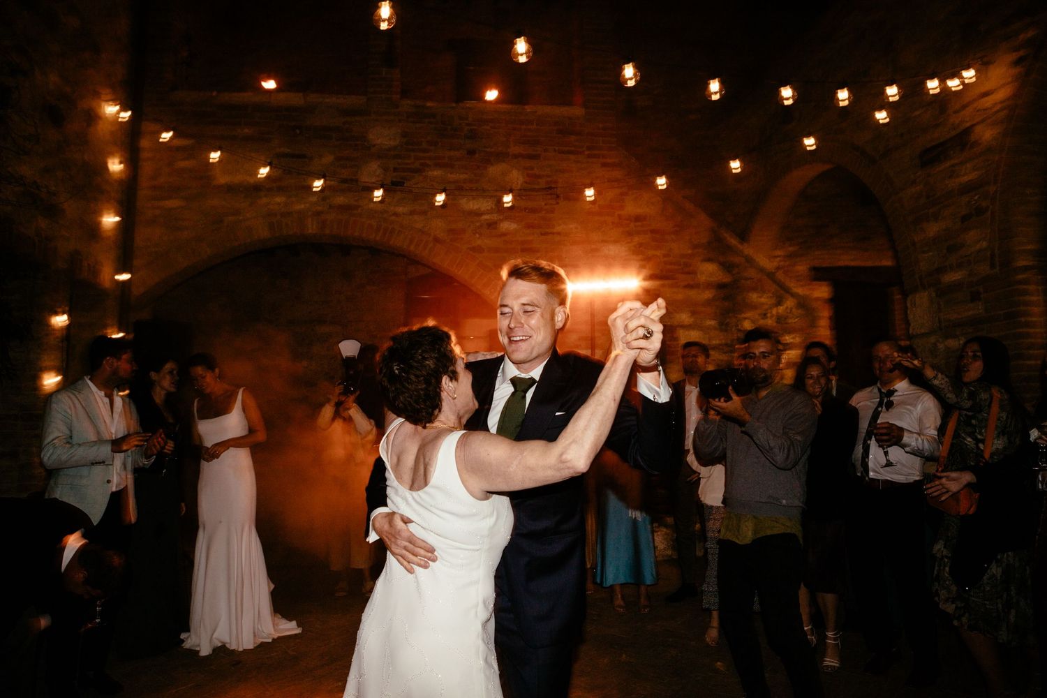 Mother and son dance at a wedding at The Lazy Olive in Tuscany.