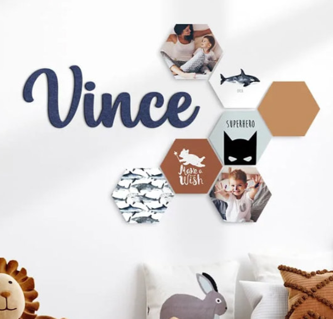Decorative wall display with navy blue text 'Vince' and hexagonal photo tiles featuring sharks and modern design elements.
