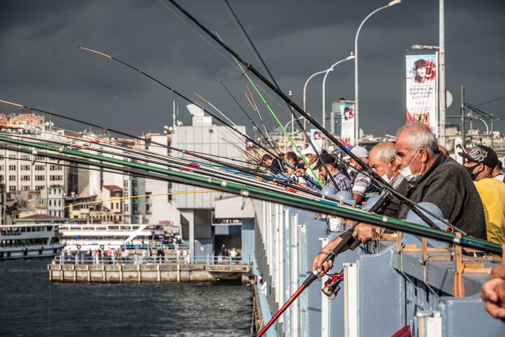 Thousands of men patiently fish on the Bosphorus River in Istanbul, Turkey.