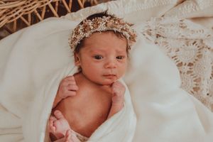 A series of similar photos showing a newborn baby lying on white fabric with soft, natural lighting.