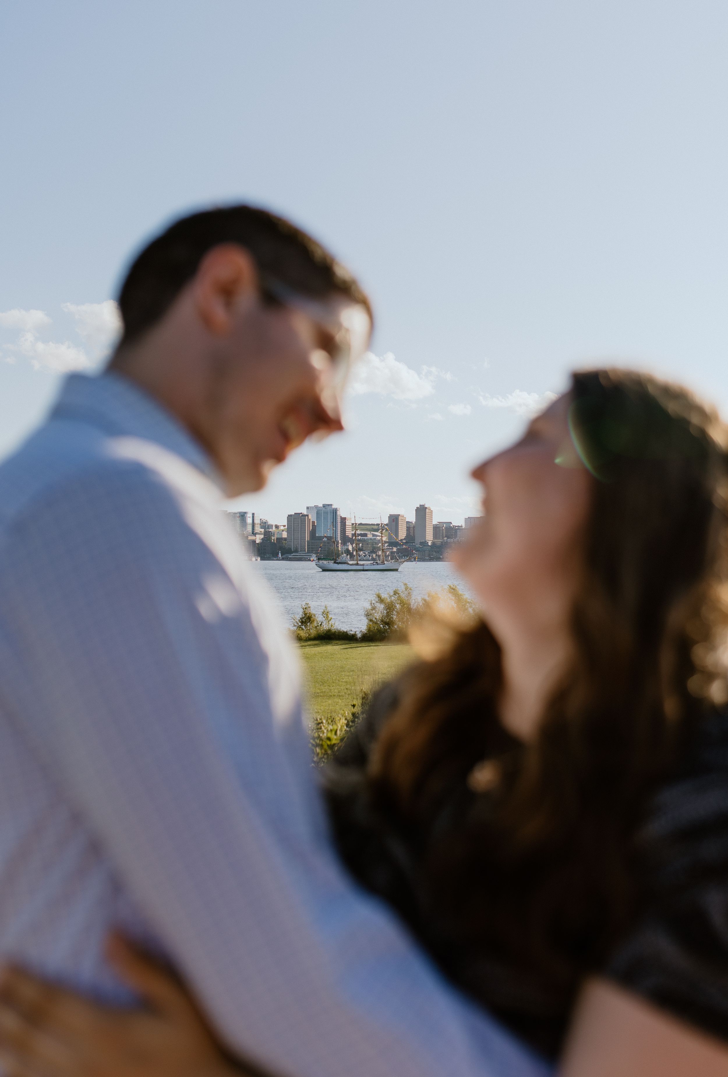A Tall Ship in the background of an engagement session along the Dartmouth Waterfront, Dartmouth, Nova Scotia Canada