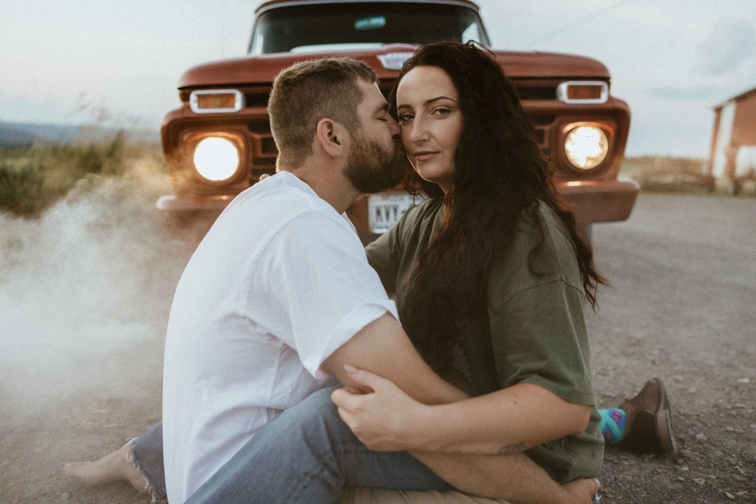 a man kissing a womans cheek in front of a    0:02 / 3:05   1966 Ford 100 Twin I-Beam Classic Pickup Truck