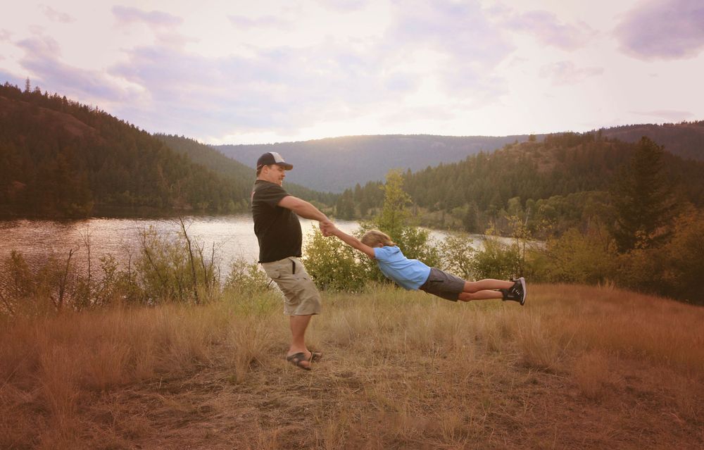 Friends having fun outdoors against mountain backdrop at dusk.