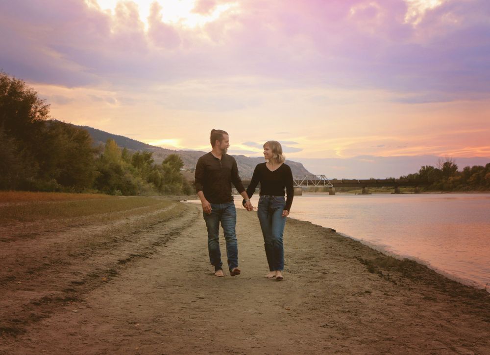 People strolling together on a coastal trail during golden hour.