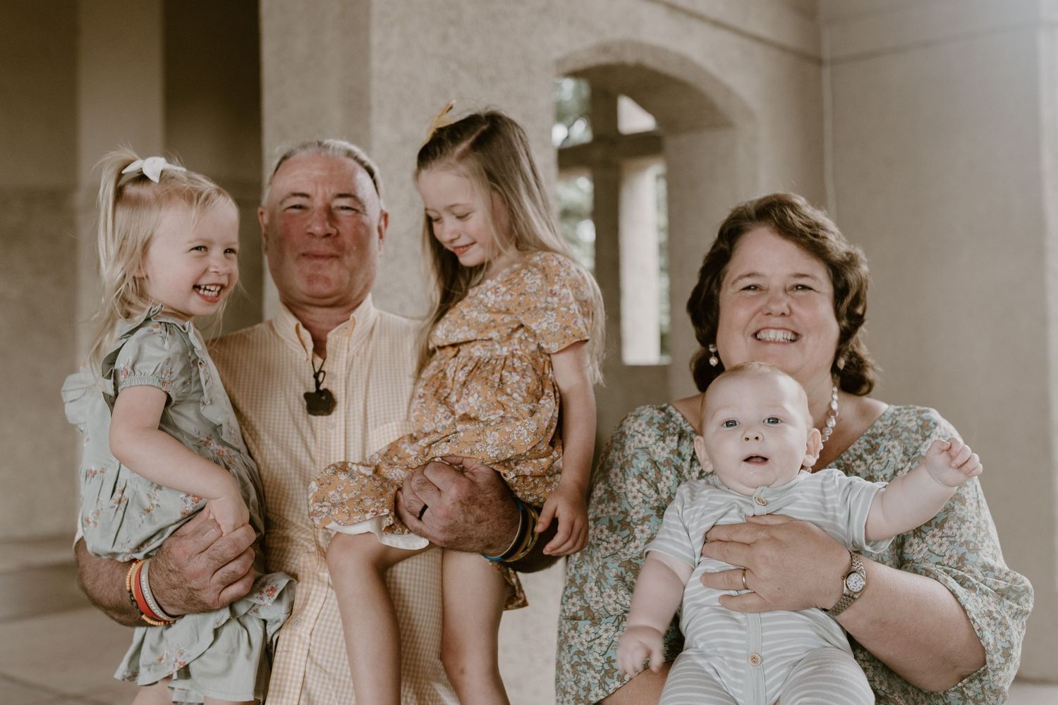 Candid family portrait in Joplin, Missouri captured in natural light by Modern Moods Imagery, showing genuine connection and movement.