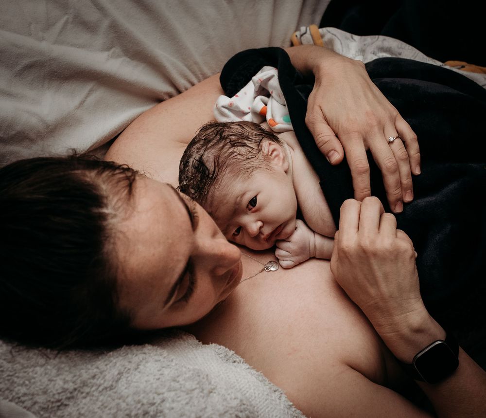 Black and white photo series capturing intimate skin-to-skin bonding moments.