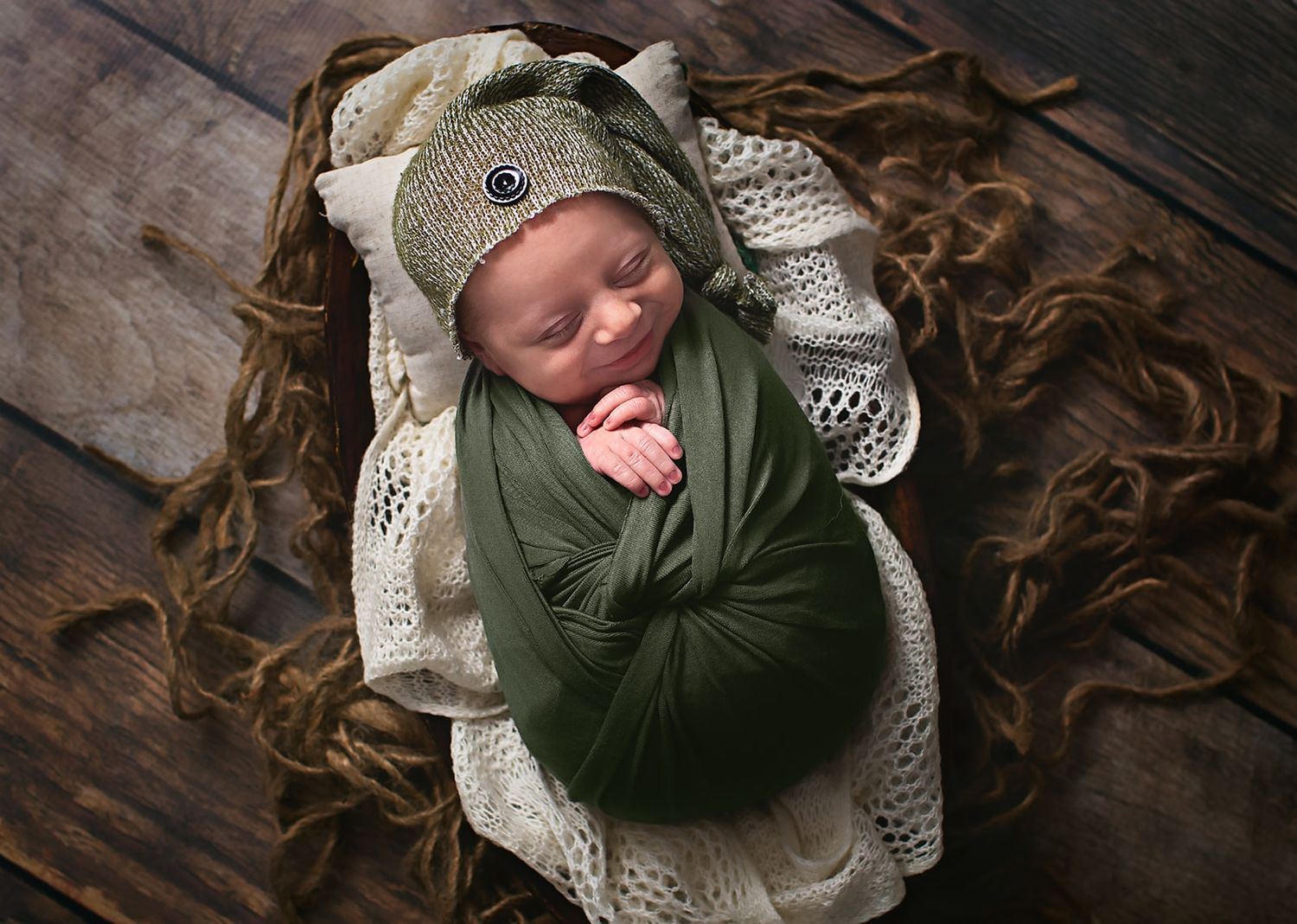 Baby smiling and snuggled in Alvin, Tx photography studio
