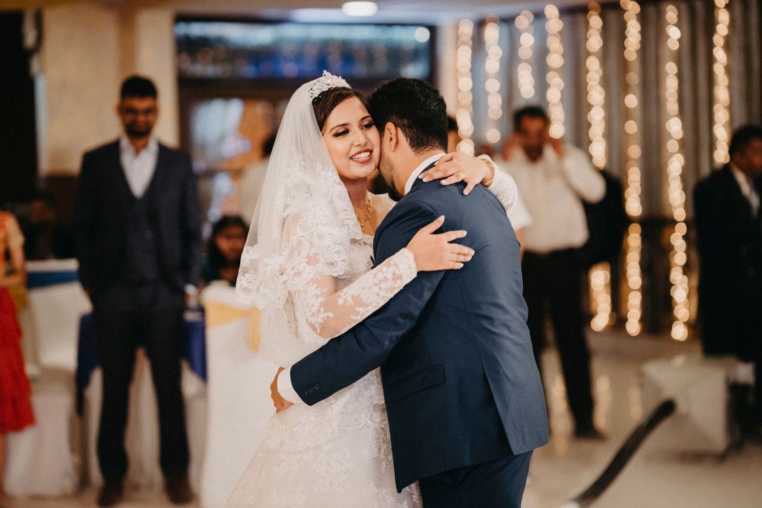 Wedding celebration captured in a series of emotional moments at an indoor venue.