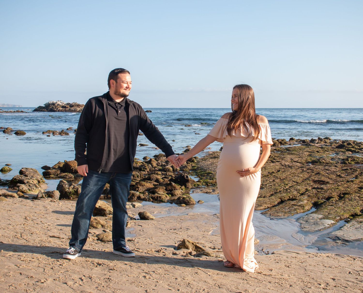 Maternity session holding hands in Laguna Beach
