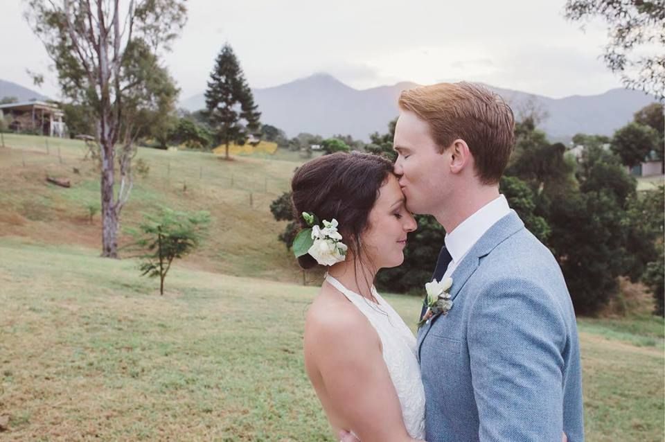 Groom kissing bride's forehead at Brisbane wedding