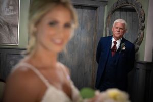 An emotional moment captured in a rustic room with vintage wooden doors.