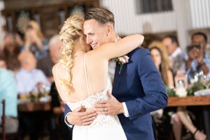 Intimate first dance moment captured under soft lighting at wedding reception.