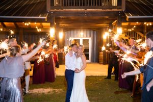 Newlyweds share a romantic moment during a sparkler exit at their wedding.