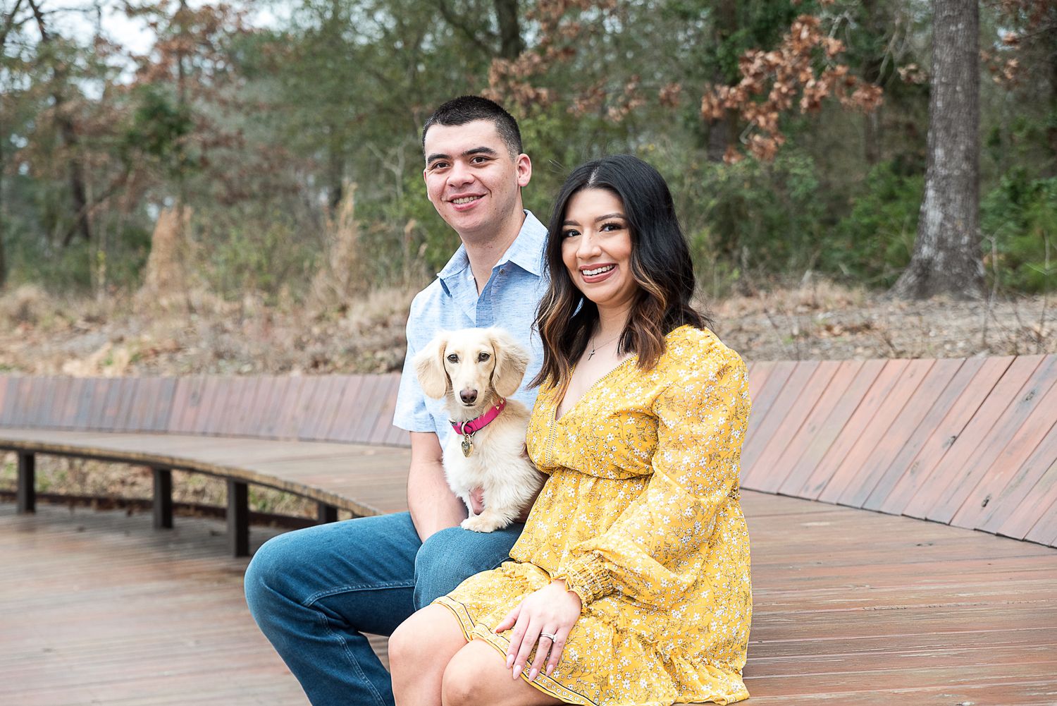 couple posing with their dog at Houston Memorial Park
