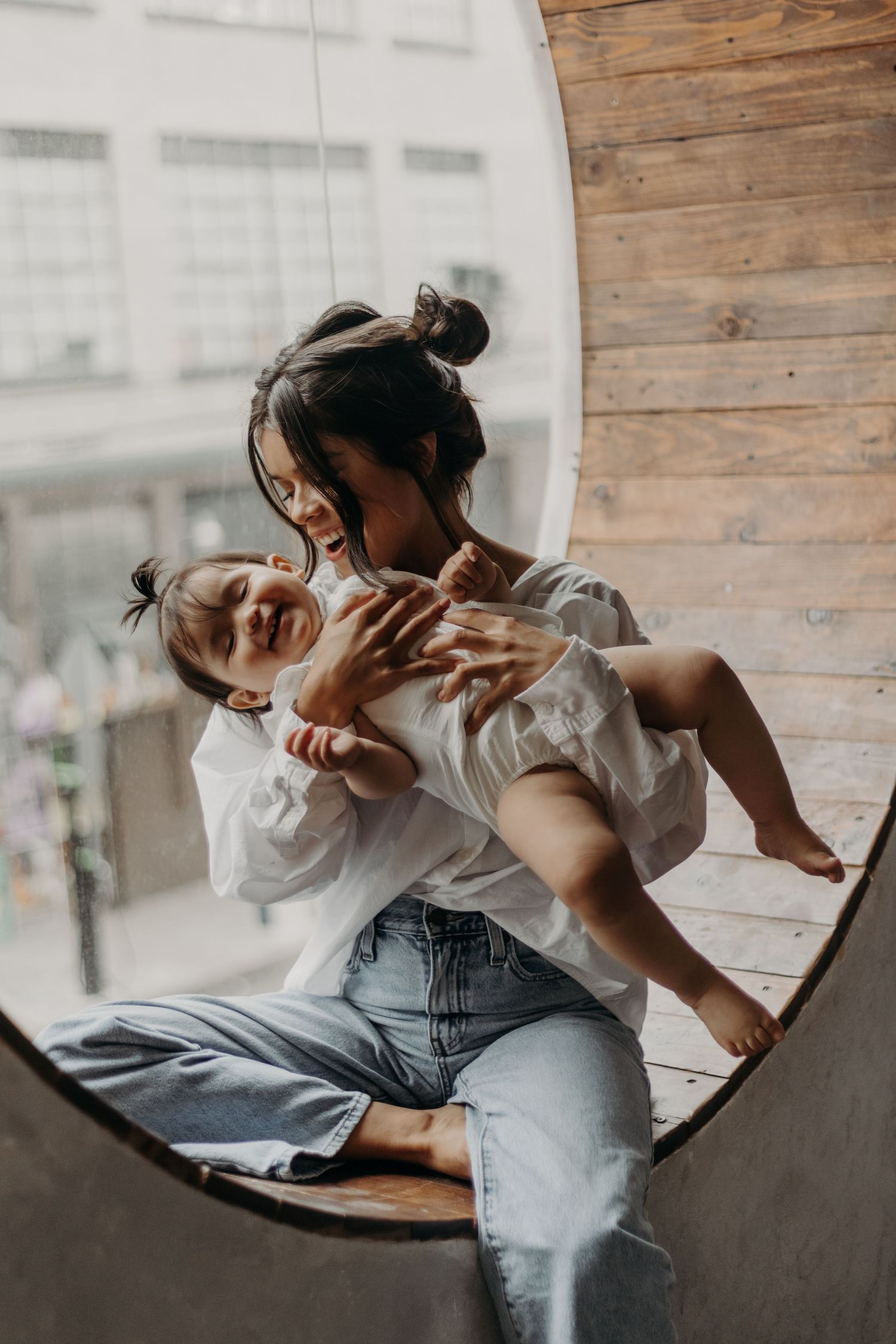 A tender moment between parent and child captured in a mirror reflection.