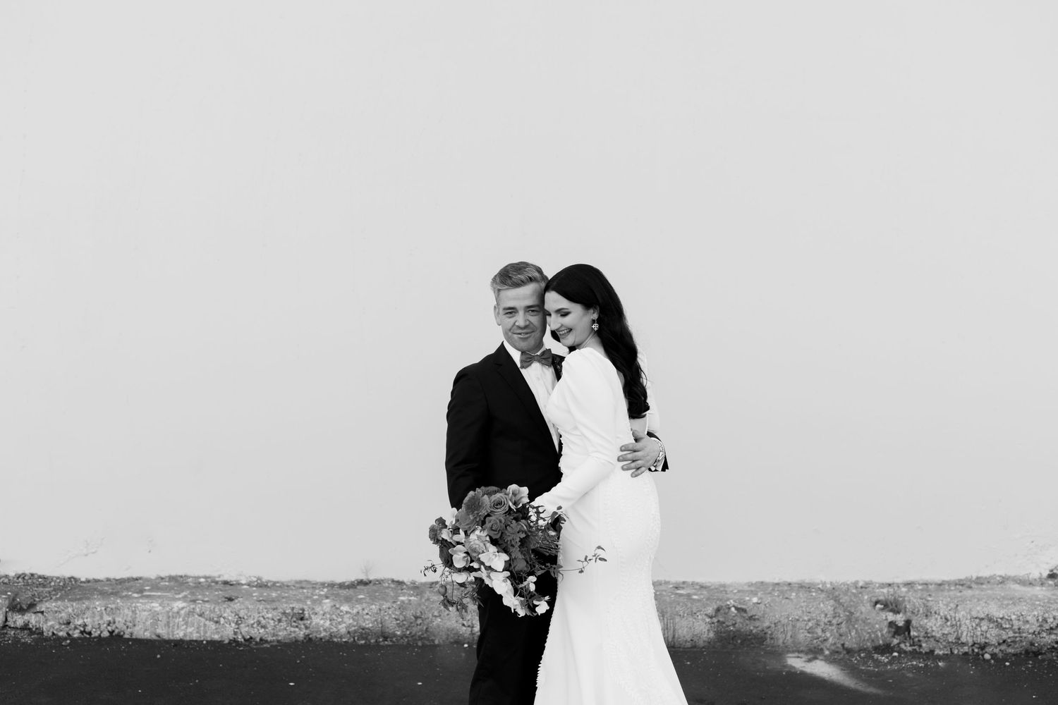 Black and white portrait of wedding couple sharing intimate moment.