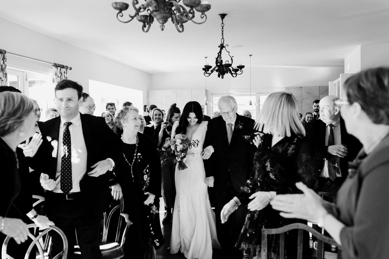 Black and white photo of wedding ceremony with guests in attendance.