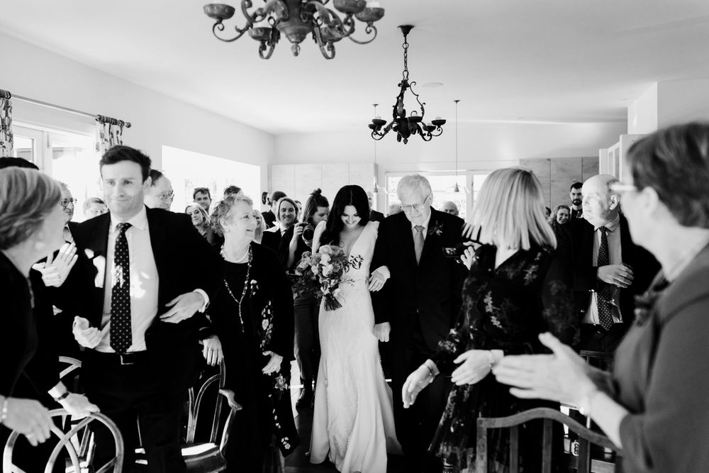 Black and white photo of wedding ceremony with guests in attendance.