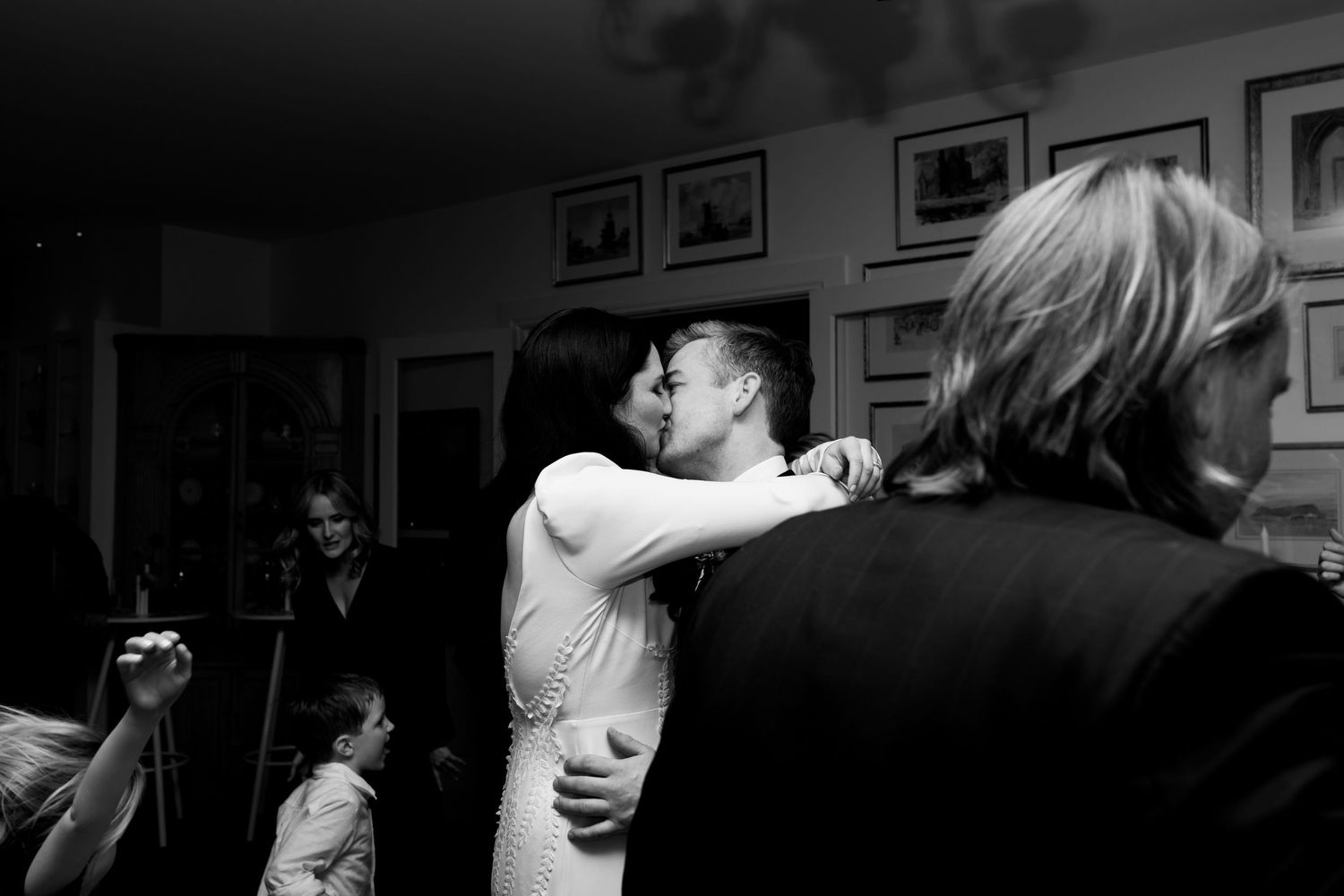 Black and white intimate moment captured during wedding reception dance.