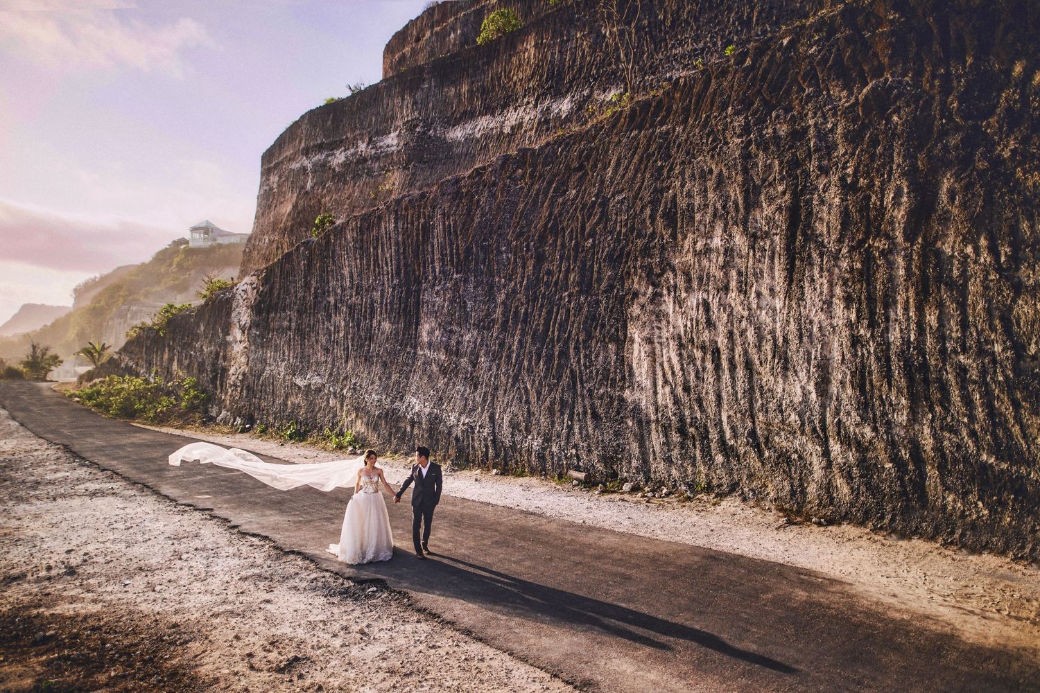 Scenic wedding photos captured along dramatic coastal cliffs and rocky shoreline.