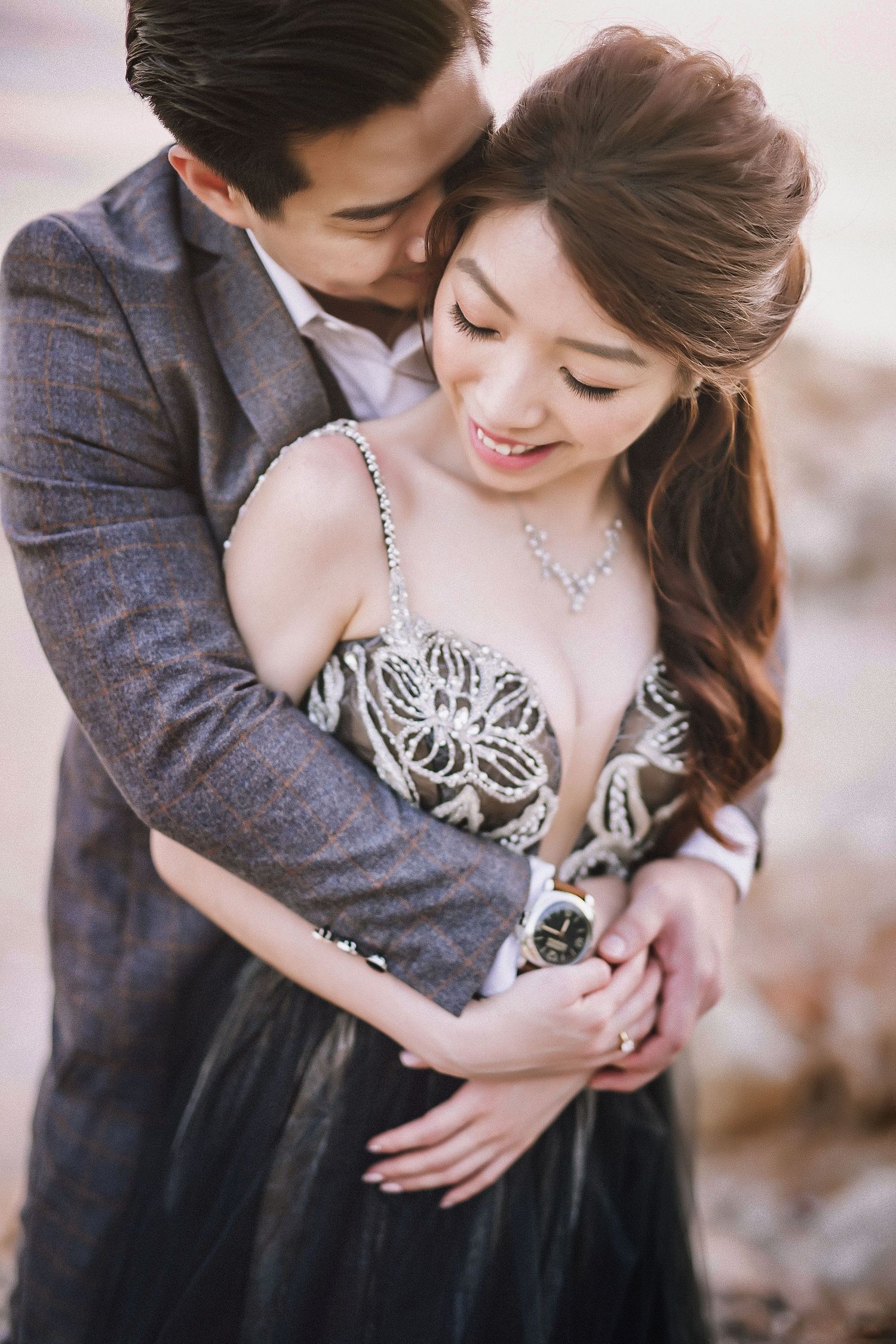 Intimate close-up portrait showing delicate lace details and tender embrace.