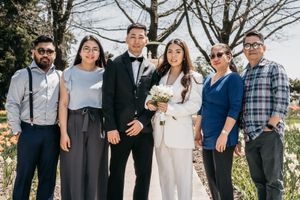Groom and Bride family looking at the camera in front of beautiful flowers