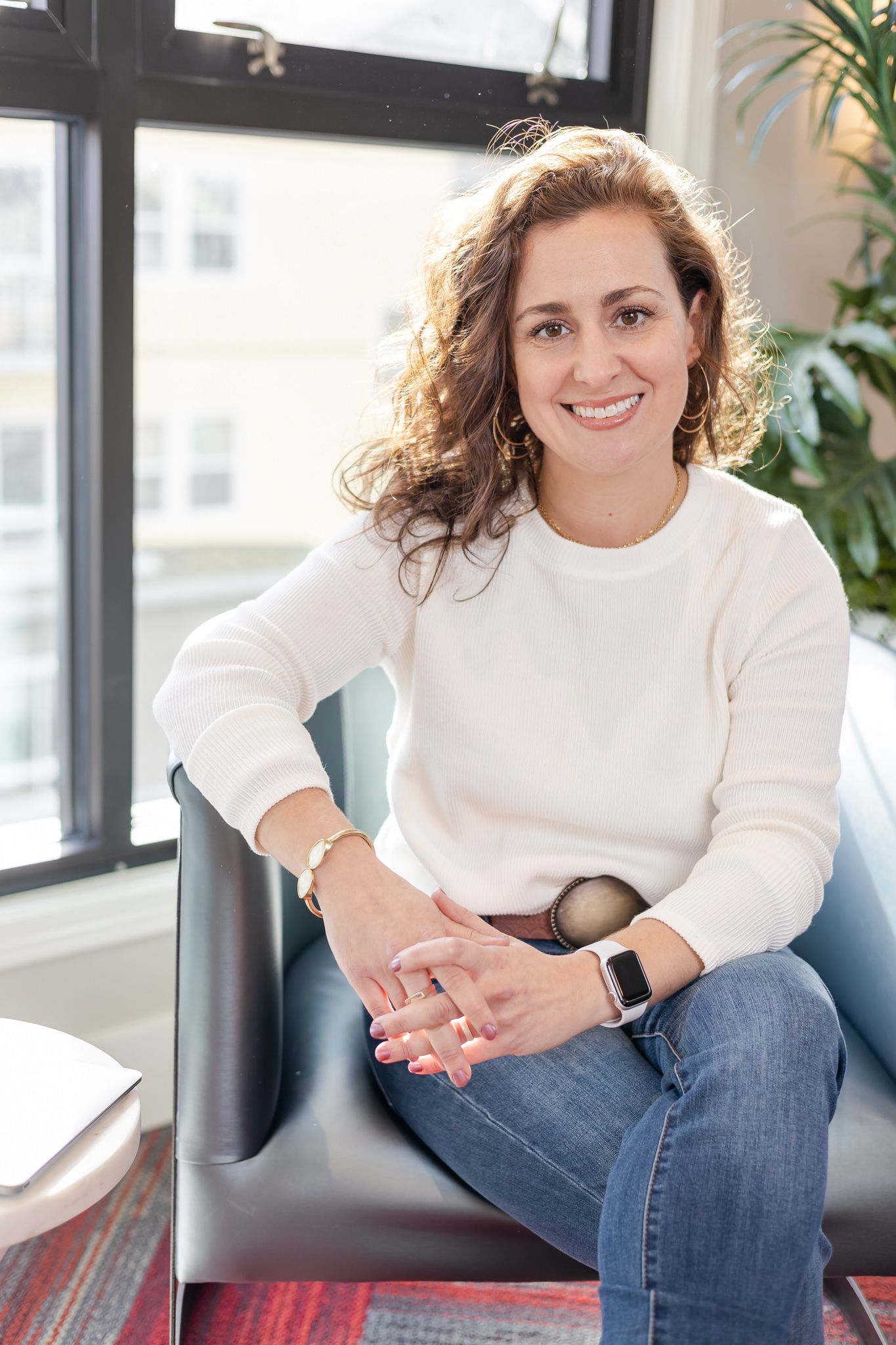 woman sitting on chair for headshots, sun hair lights in Woodinville, WA