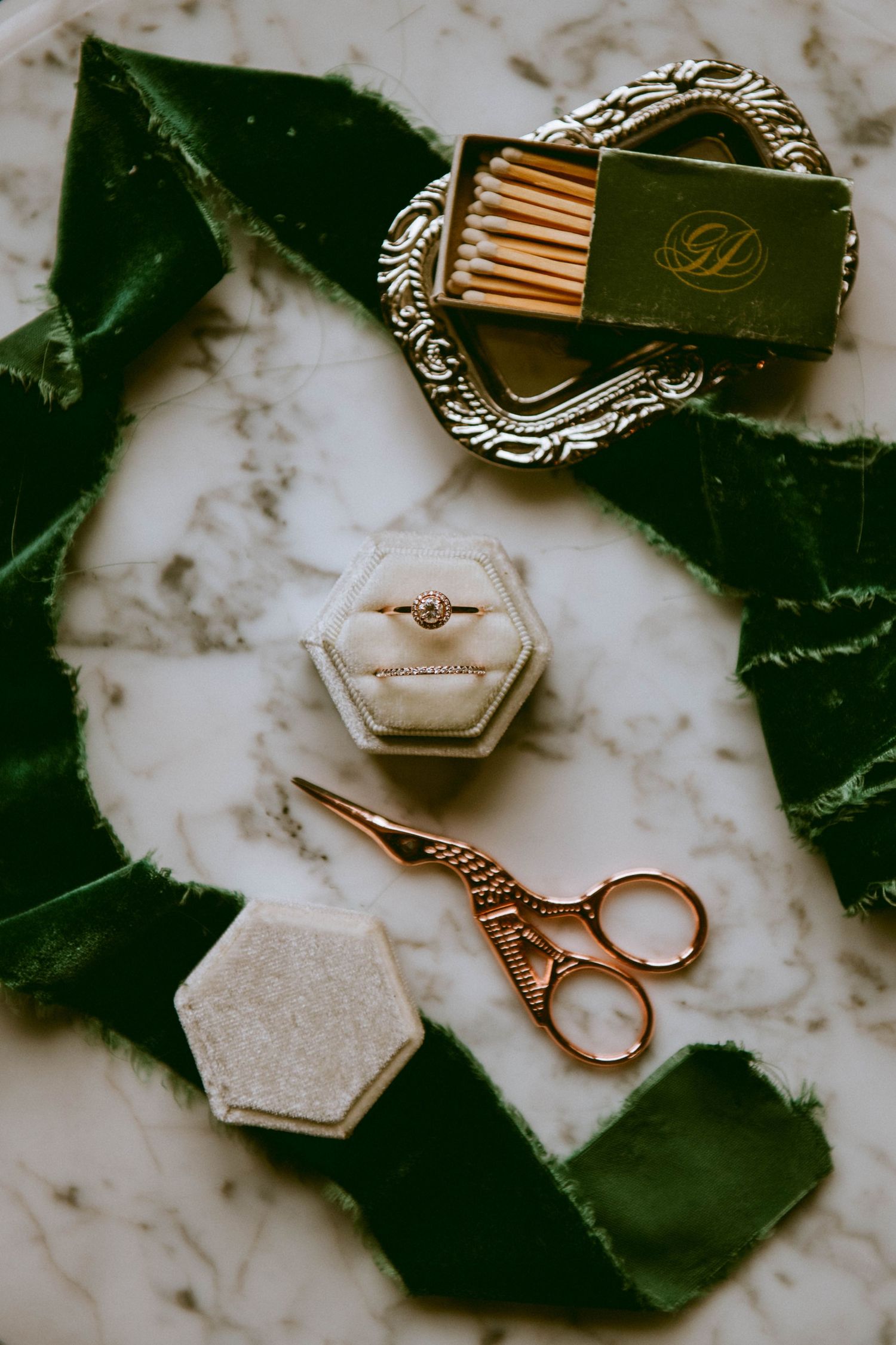 image of engagement ring and wedding band with green velvet ribbon