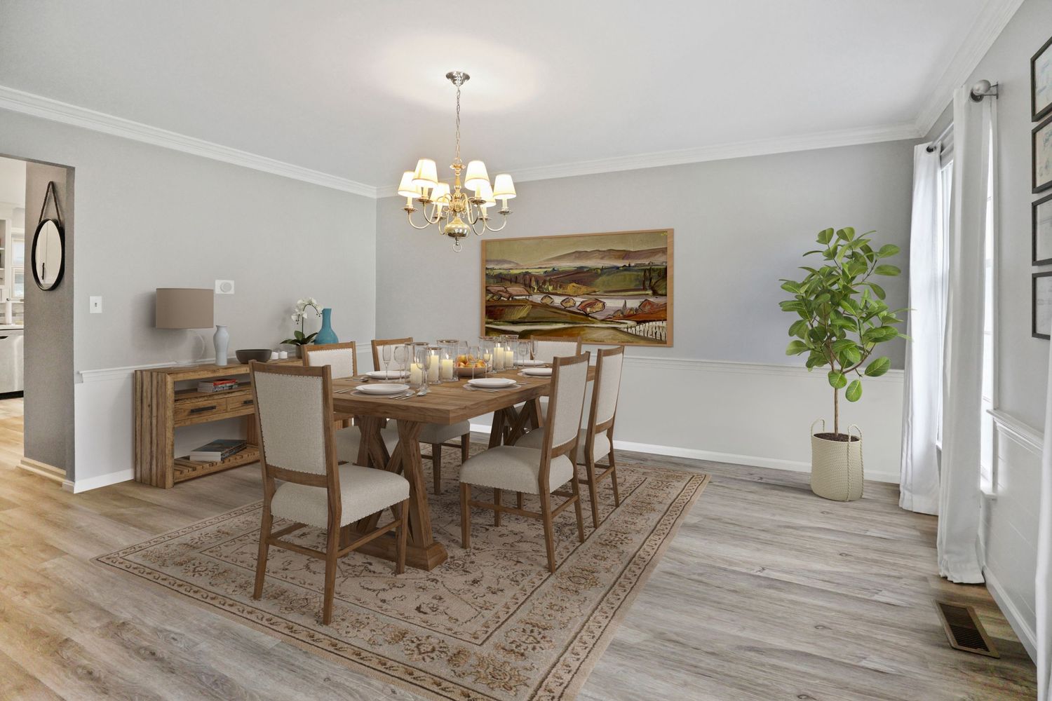 Modern dining room with white walls, wood flooring, chandelier, and rustic farmhouse decor in a bright open space.