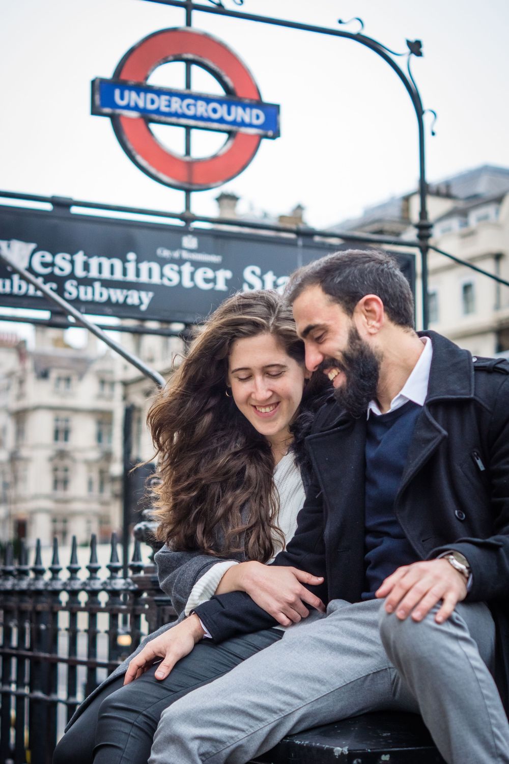 A couple smiling in engagement photoshoot in Westminster London