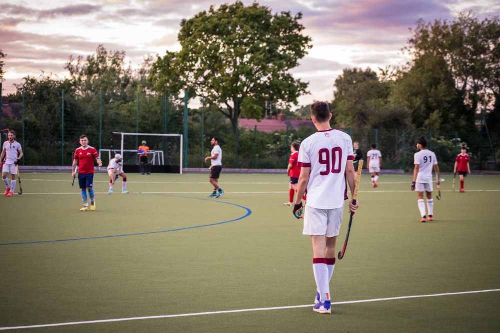 Players at Redditch Hockey Club in a summer league game with dramatic sky