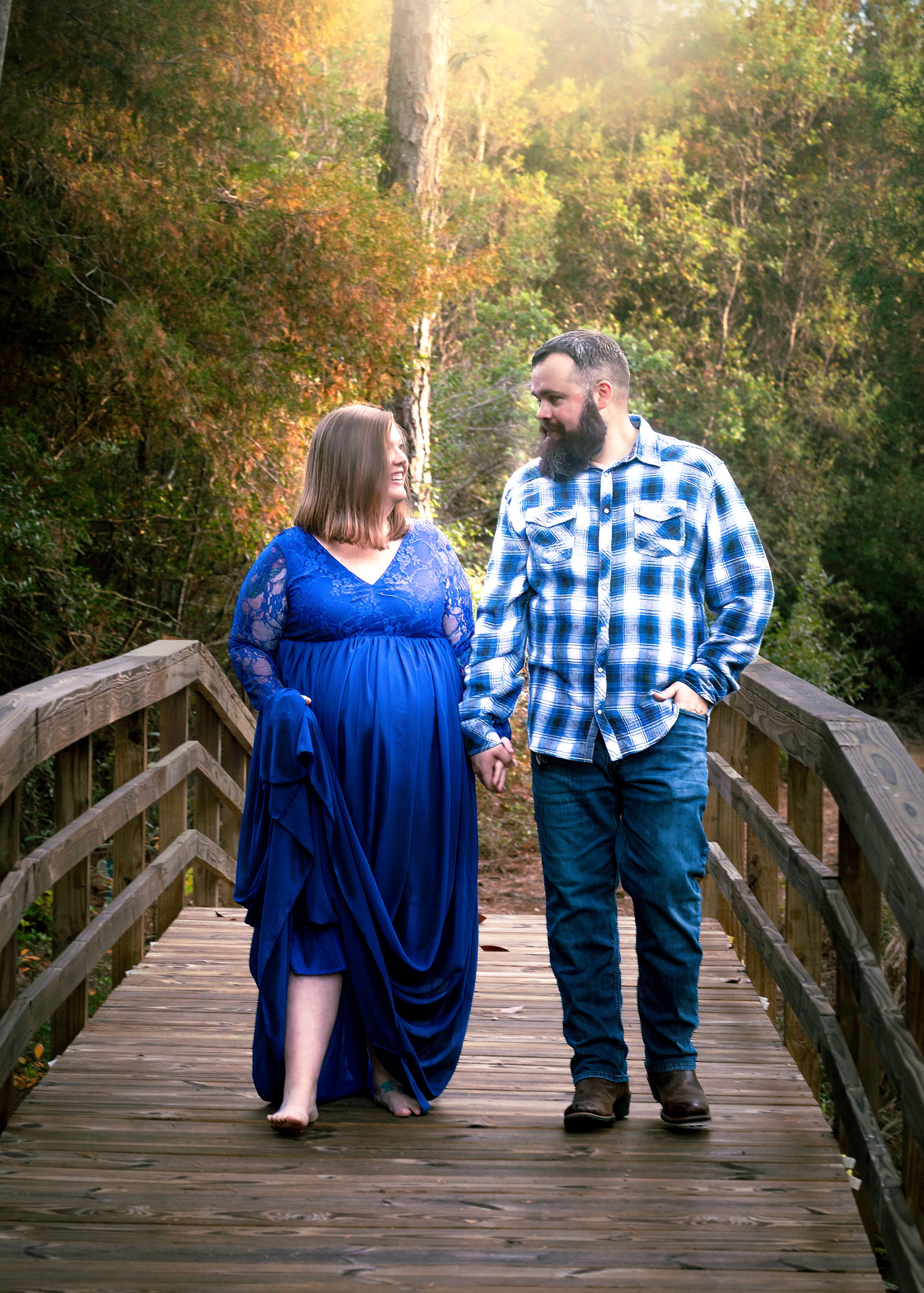 Elegant Couple Maternity in Blue Dress on Bridge