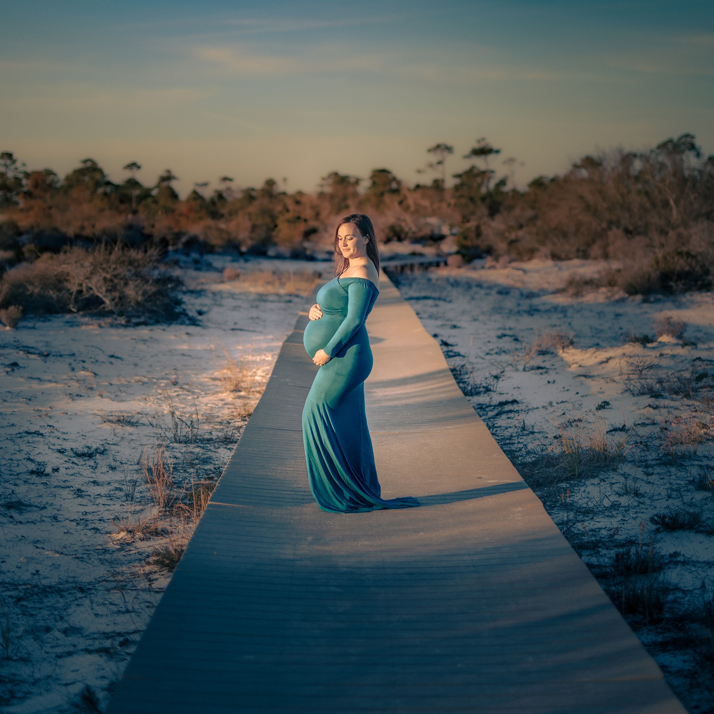 Dramatic Maternity Fort Pickens Beach Walkway in Teal Dress