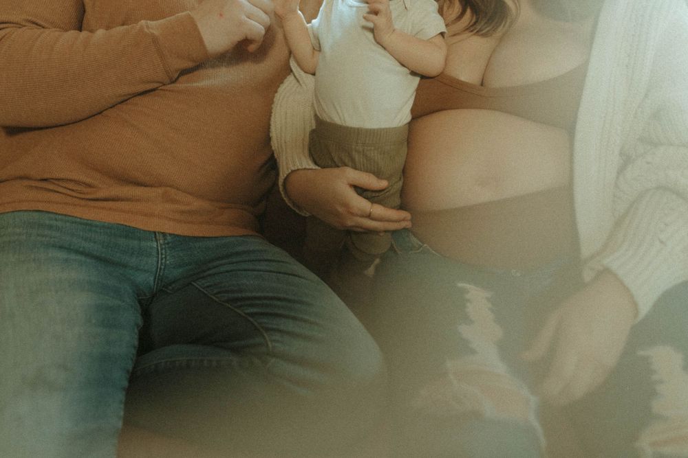 Close up shot of family sitting together on couch.