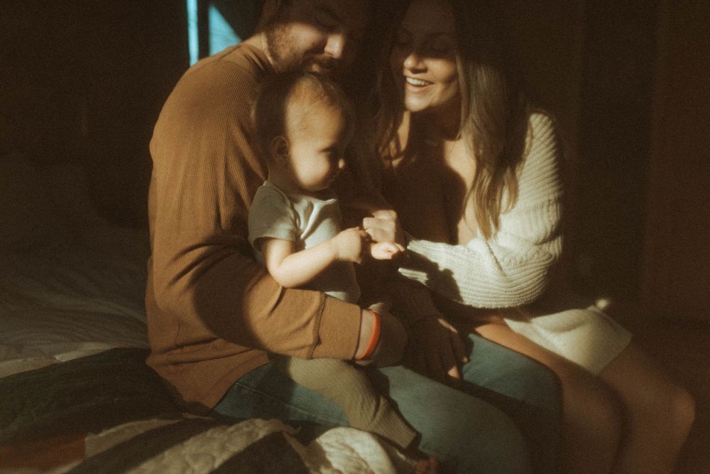 Family moment captured in warm sepia tones with intimate lighting.