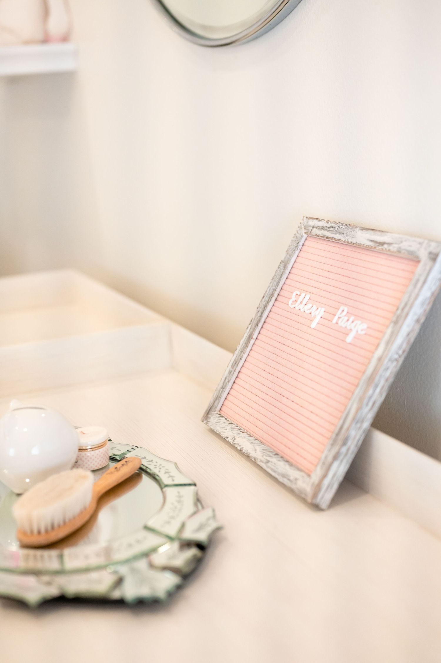 pink and white letter board with the baby ellery paige decoration in a baby girl nursery for a lifestyle session