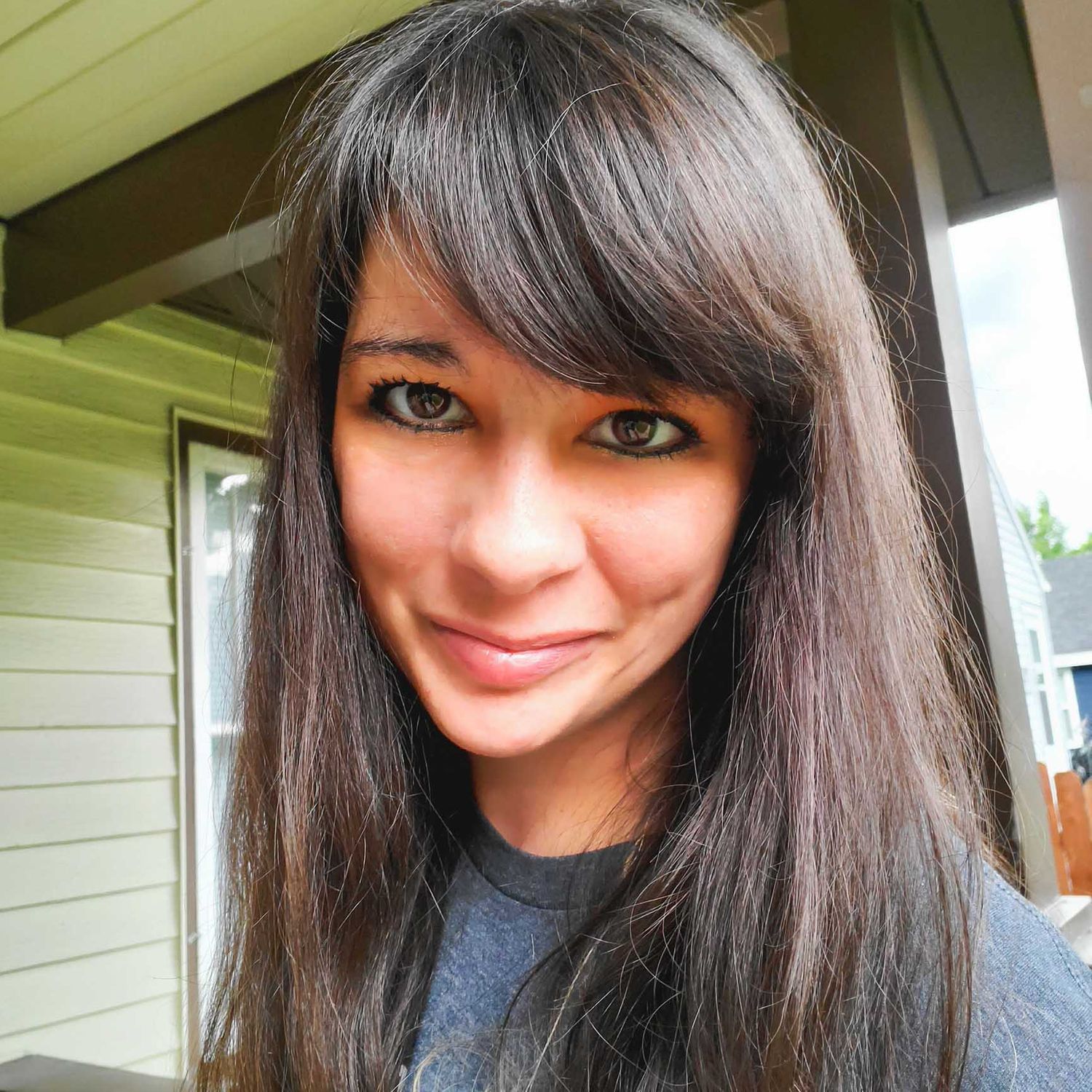 Ashleigh B., a smiling Whidbey Island photographer, in a casual outdoor headshot."
