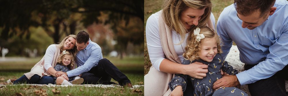 A candid family portrait session showing playful moments on a white blanket in a park during autumn.