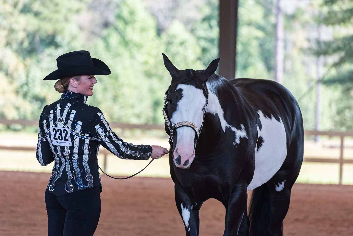 Woman with red lipstick shows black and white paint in showmanship in Camden, South Carolina.
