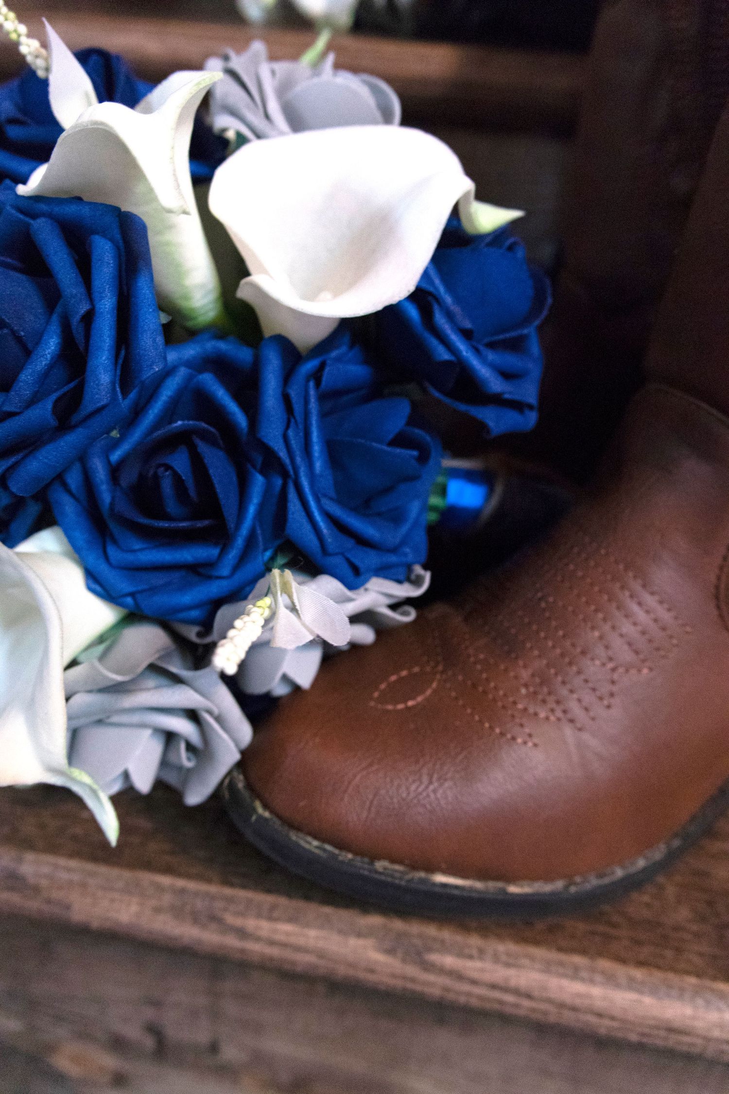 Cowboy book with blue rose bouquet
