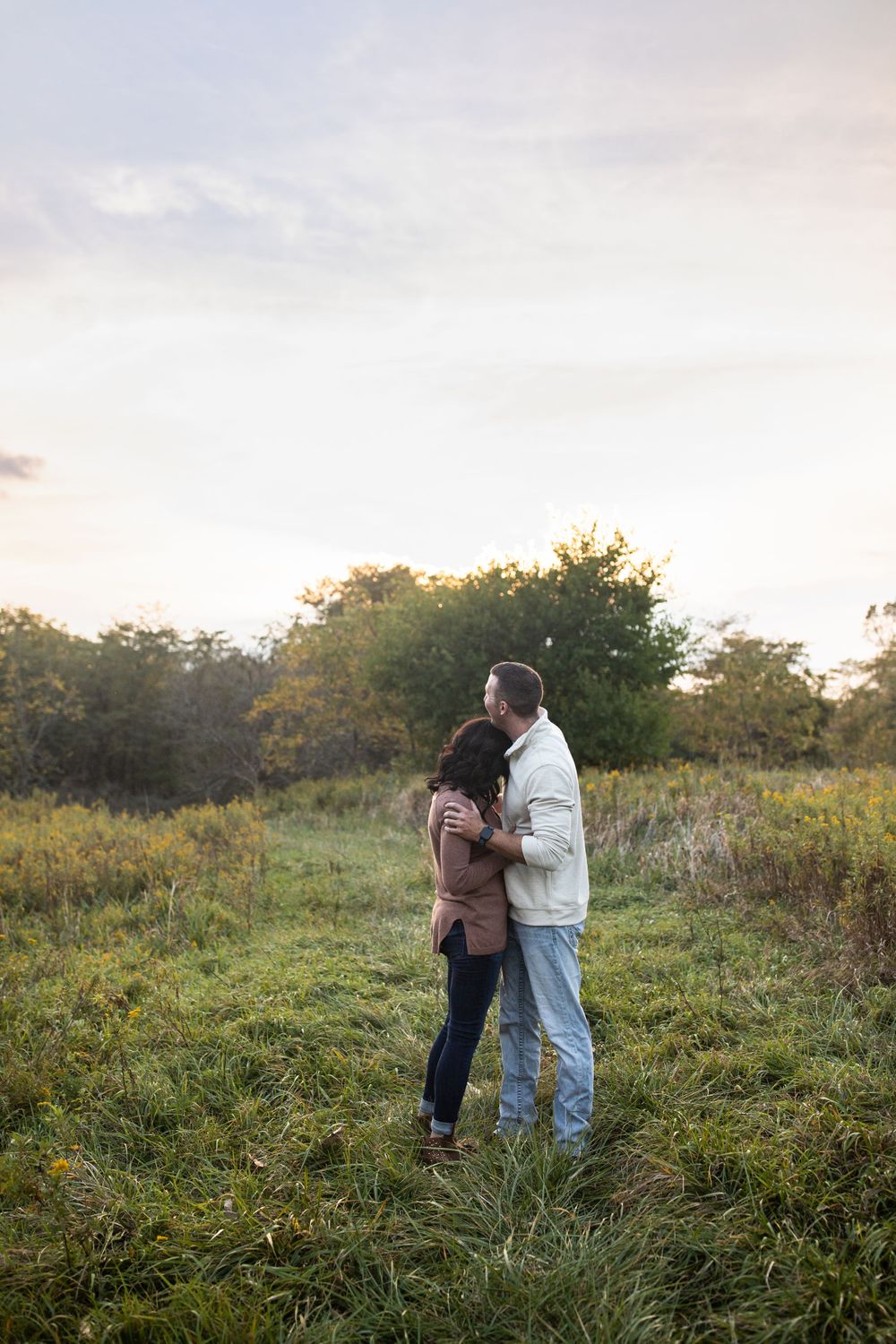 Couple Cuddling in field in Marion, Indiana. Marion Indiana Couple Photographer