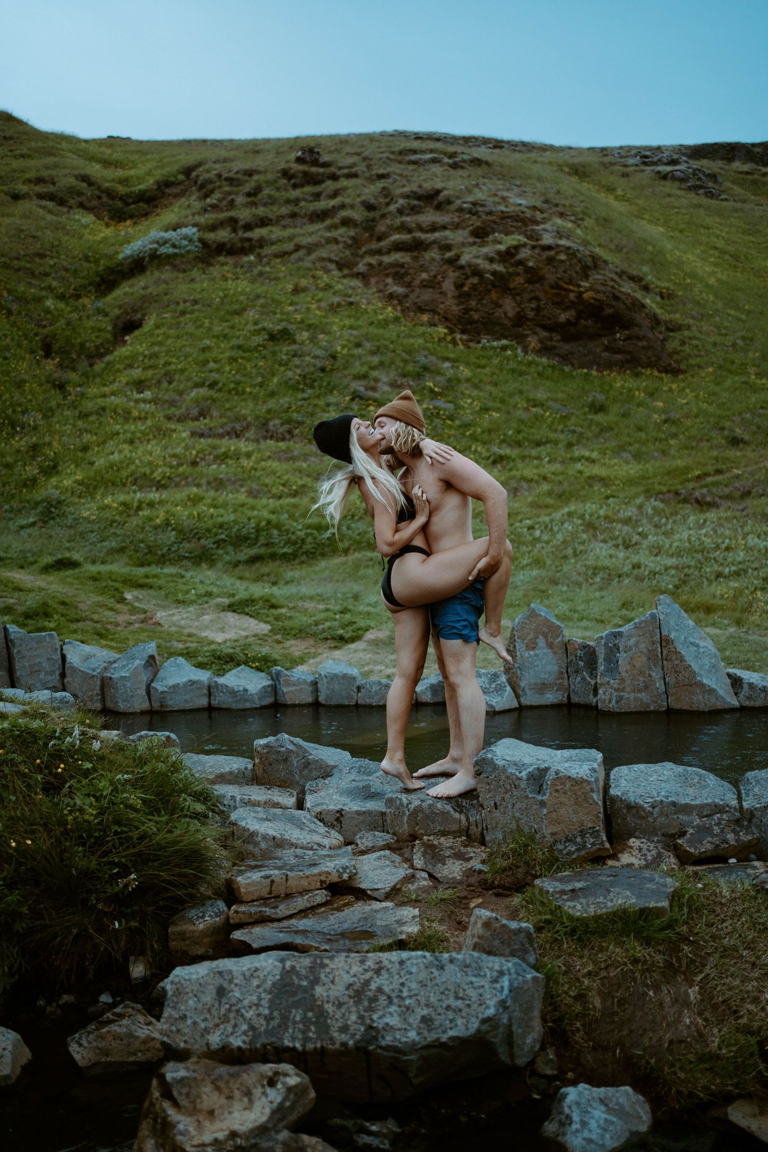 A playful moment captured on rocky terrain near natural hot springs in Iceland.