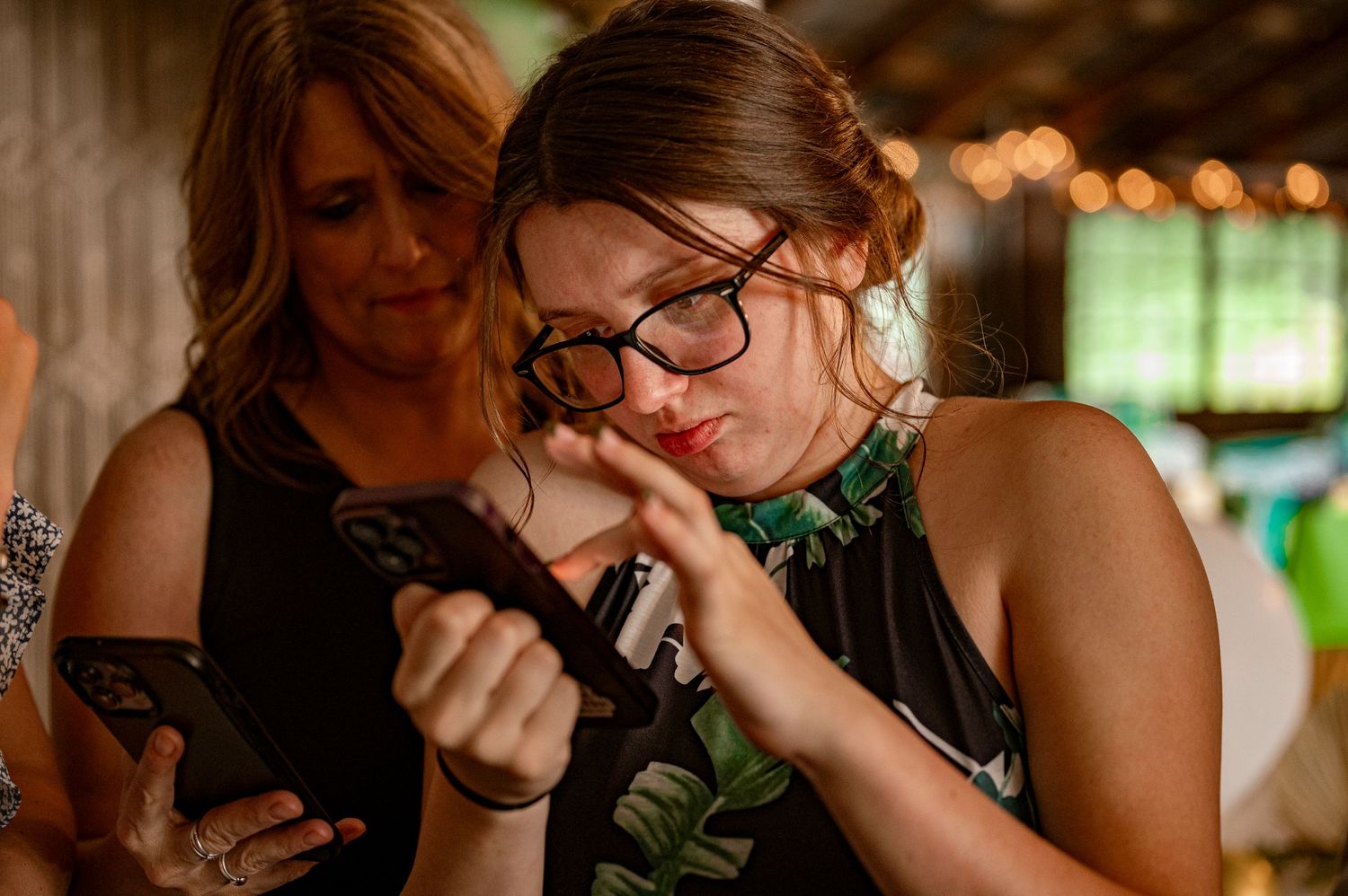 A guest checking their phone during a wedding reception.