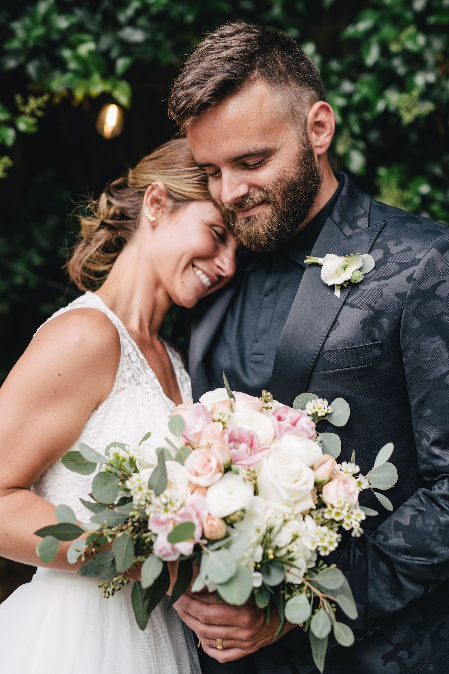 A romantic wedding moment with a beautiful blush and white floral bouquet featuring eucalyptus greenery.