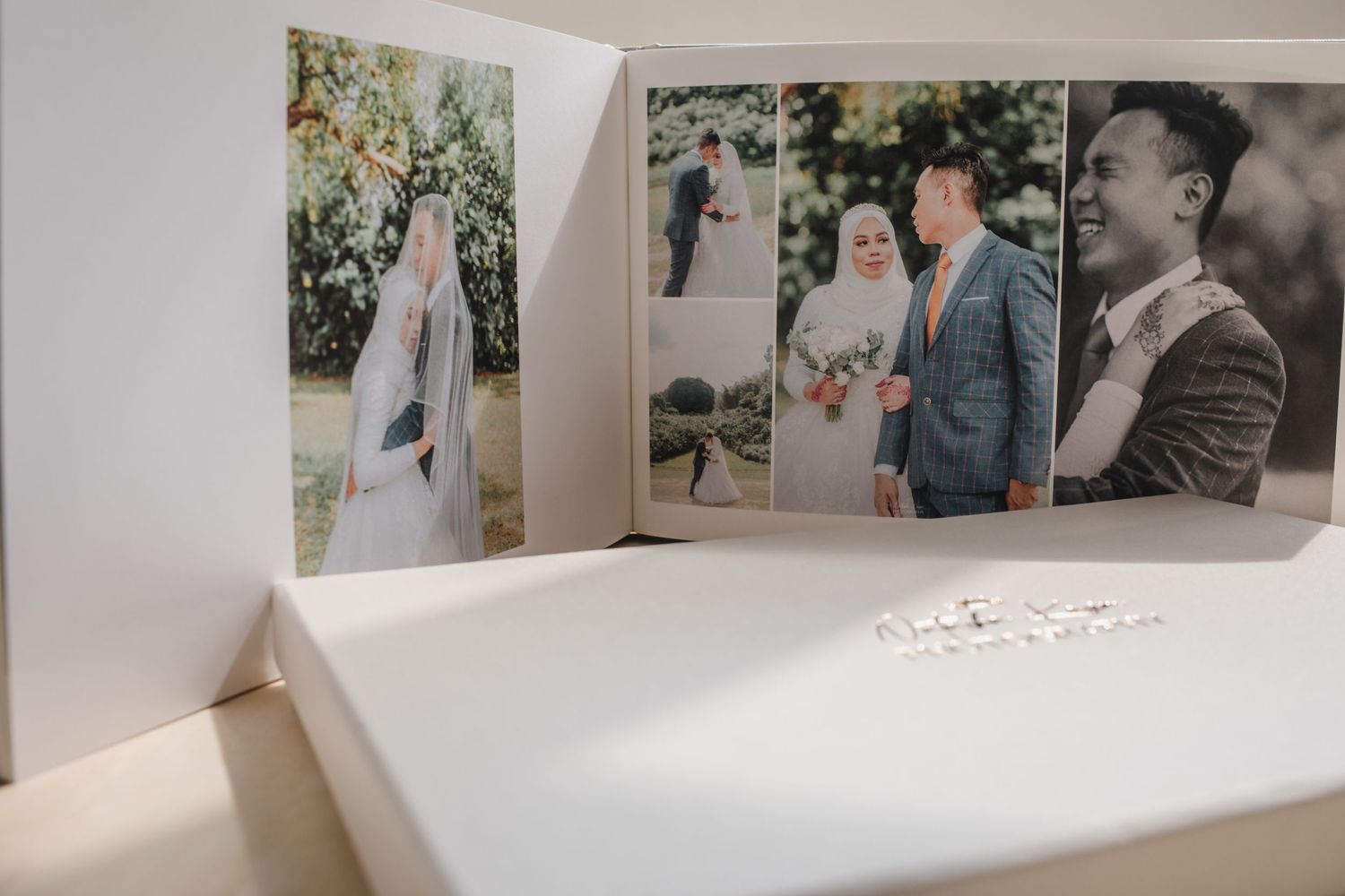 Wedding album spread showing multiple ceremony and couple photographs in white layout.