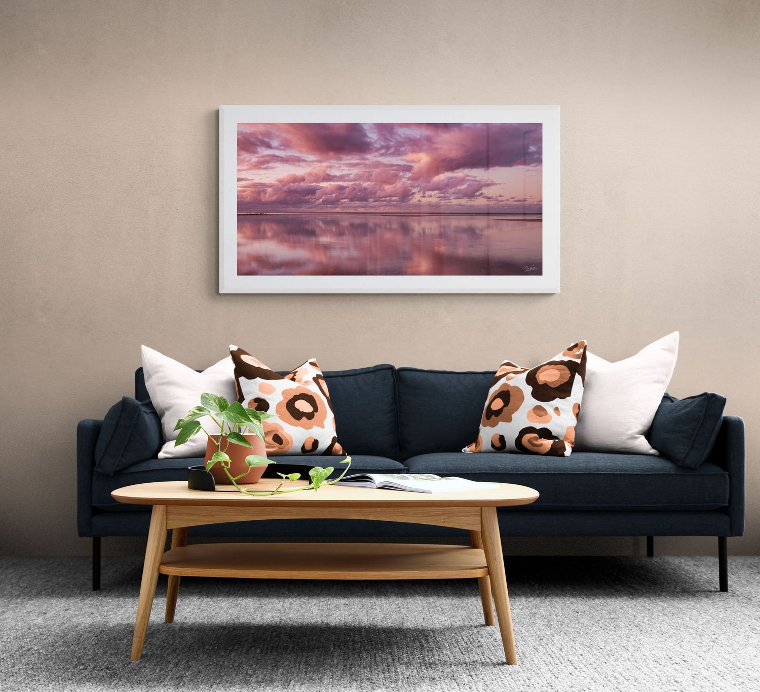 Modern living room featuring a navy sofa, artwork, and decorative pet-themed pillows.