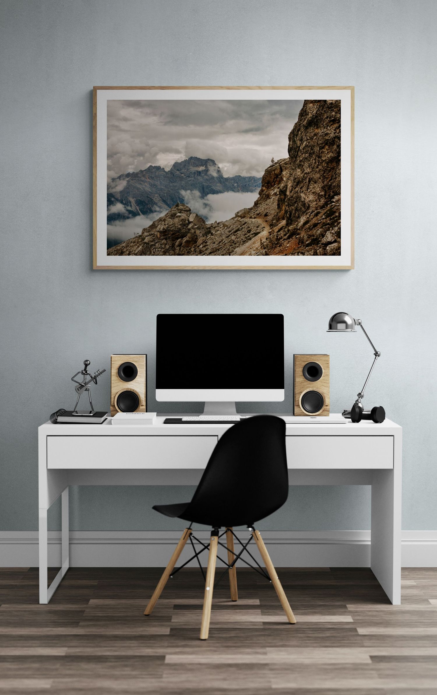 Minimalist home office setup with mountain landscape artwork and modern computer workstation.