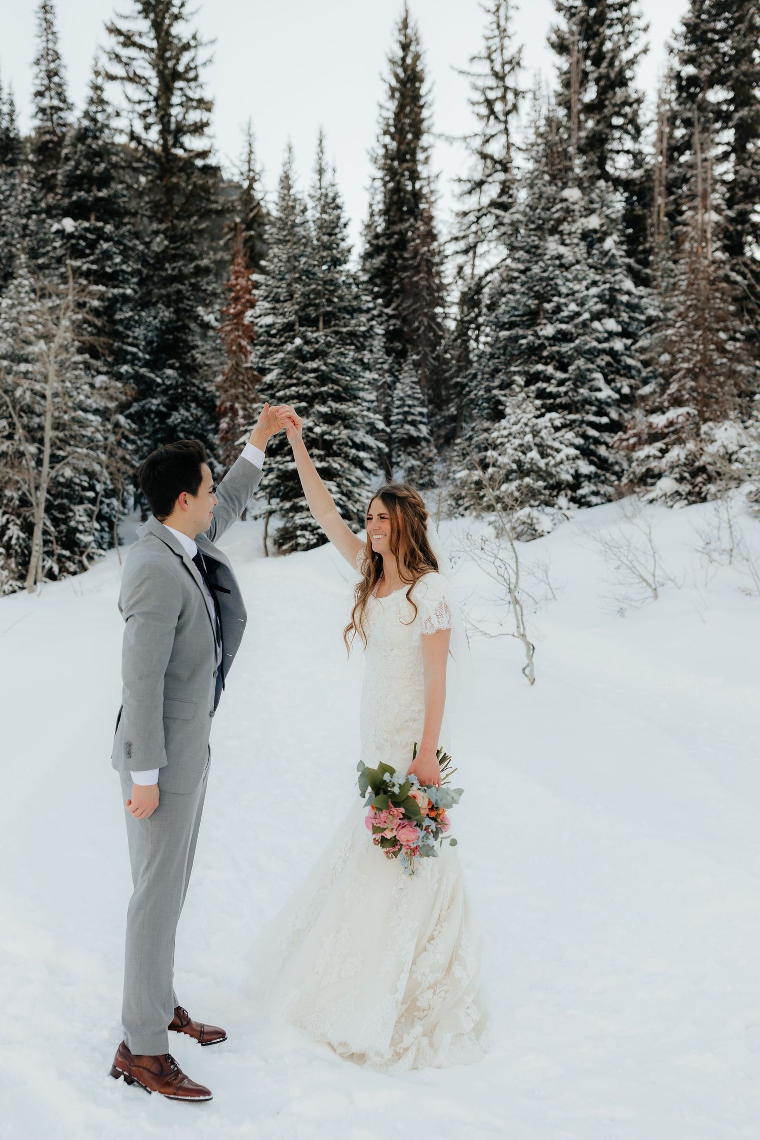 Bride and Groom dancing Utah winter mountains